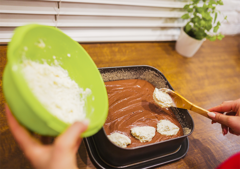 Mixing yogurt in lemon cake recipe